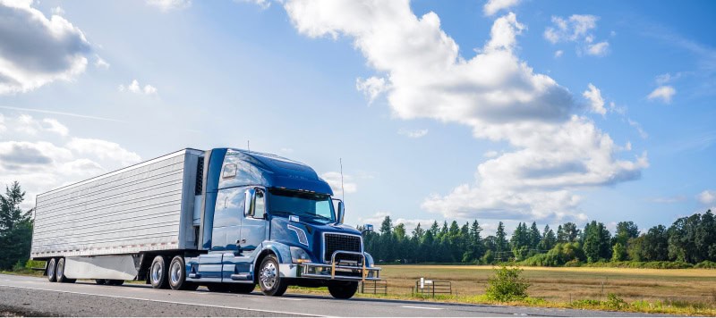 semi truck driving down road