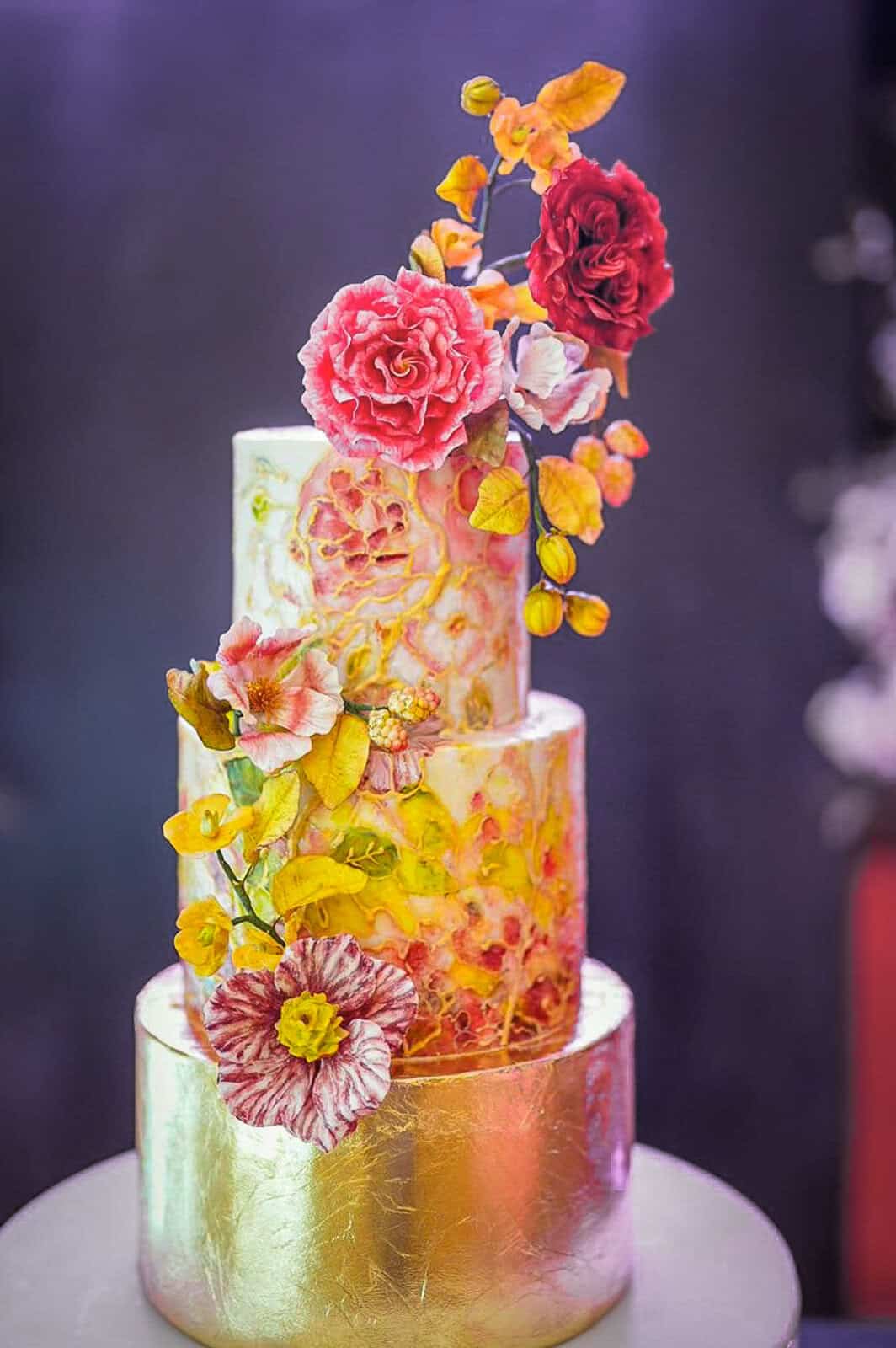 Luxury birthday cake with stained glass effect, colorful hand-painted flowers, and gold leaf at Piazzale Michelangelo in Florence, Italy.