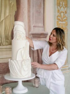 White tiered wedding cake with sculptural draped fondant at Villa Corsini in Florence, Tuscany, Italy.