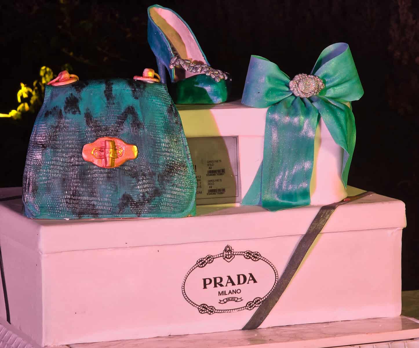 Luxury birthday cake inspired by a Prada bag with iridescent fondant, designer shoe and bow toppers at Villa Vignamaggio in Chianti, Tuscany.
