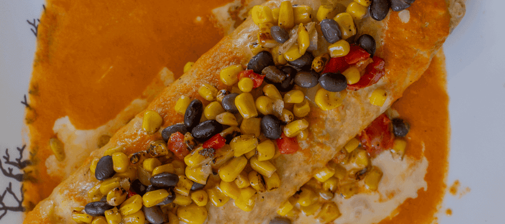 Delicious Mexican dish with corn, beans, and sauce at Vallarta event.