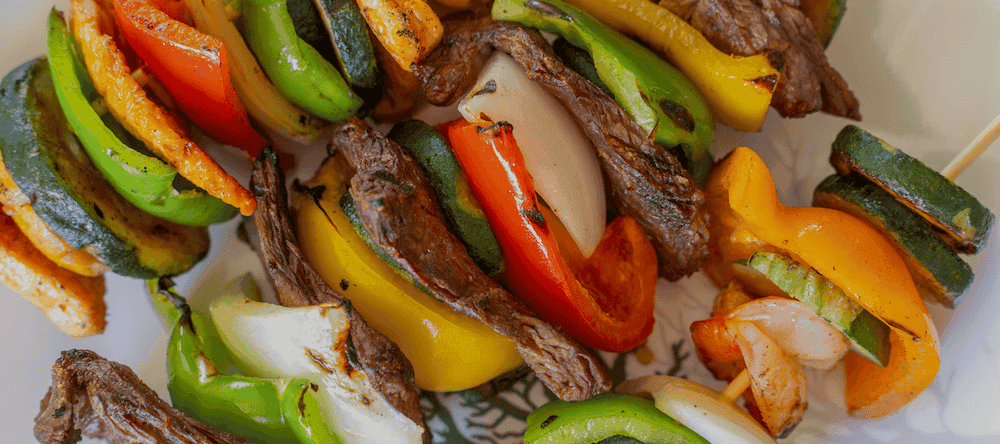Vibrant beef and vegetable skewers with peppers and onions for lunch specials.
