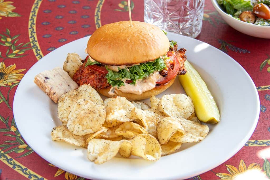 Delicious blackened grouper sandwich with lettuce and tomato on a bun.