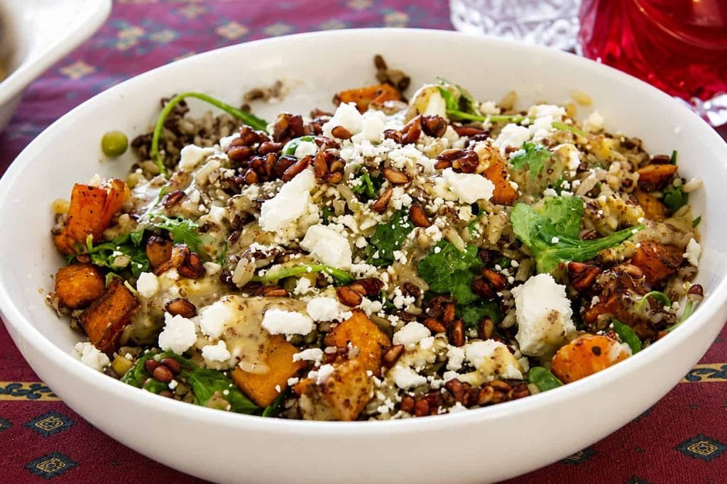 Colorful Aztec grain bowl with vegetables, cheese, and herbs for a healthy meal.