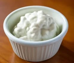 Freshly made creamy coleslaw in a white bowl at Village Baker.