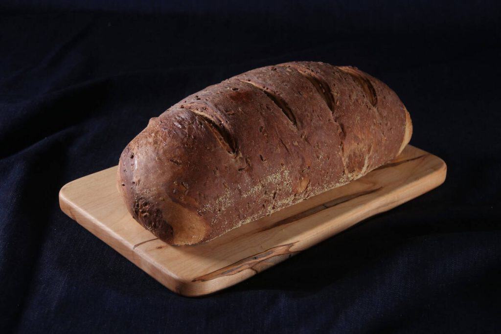 Freshly baked marbled rye bread on a wooden board.