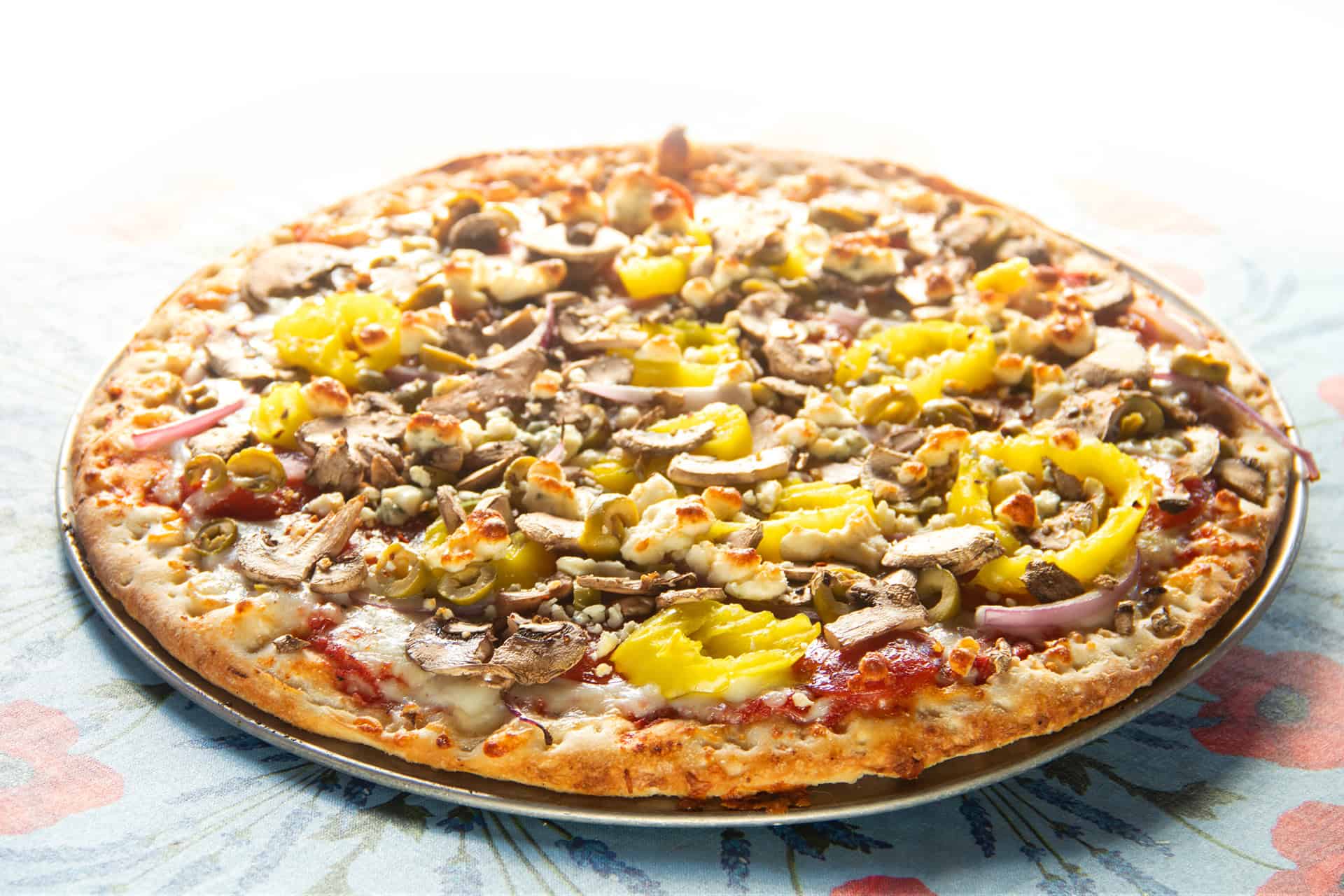 Close-up of mushroom and pineapple pizza on a plate.