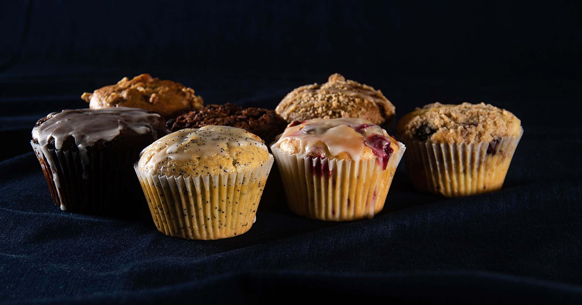 Variety of muffins including chocolate, blueberry, and bran at Village Baker.