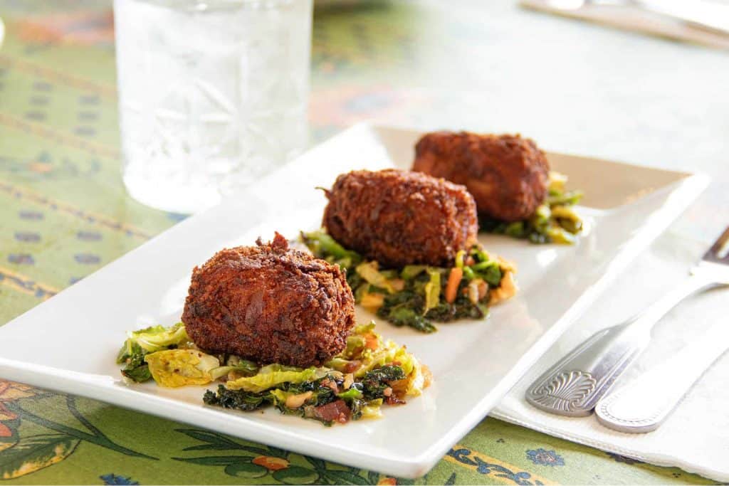 Delicious shrimp and scallop croquettes served with vegetable medley at Village Baker.