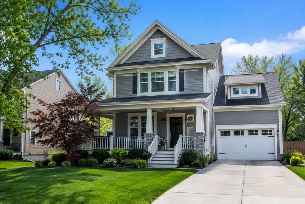 Beautiful Muskegon family house with front porch and well-kept lawn.