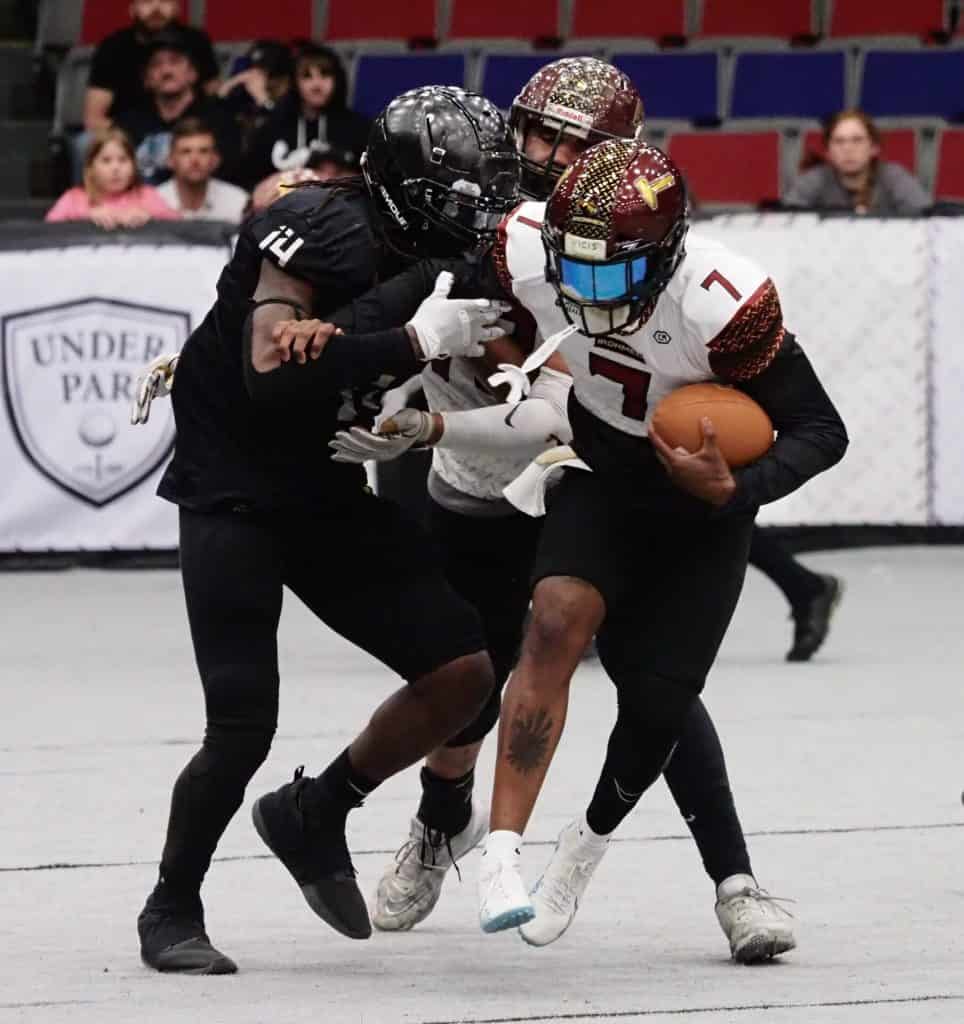 West Michigan Ironmen player running with football during game.
