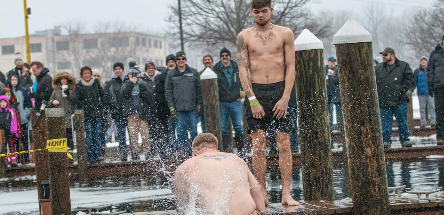 Football players and fans at a water-themed event in West Michigan.