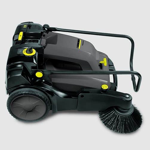 Commercial floor sweeper with black and yellow accents for industrial cleaning.