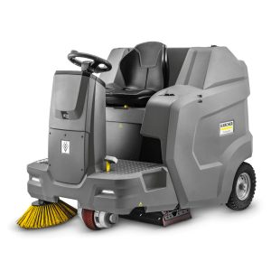 Commercial floor sweeper with yellow brush and gray body for industrial cleaning.