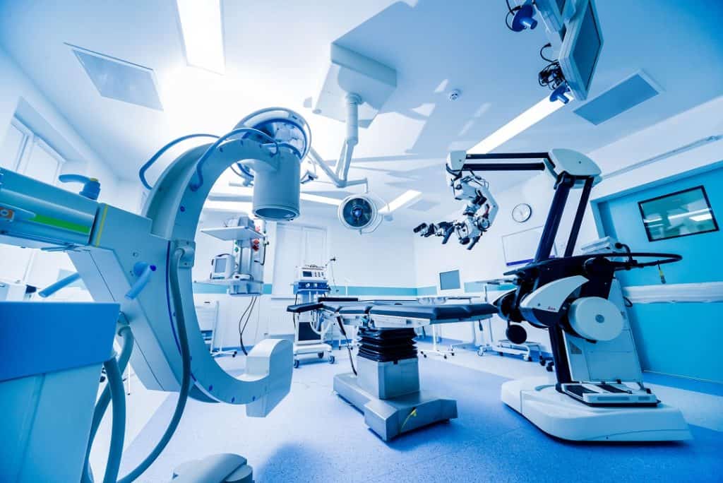 Modern medical manufacturing facility with robotic surgical systems and advanced machinery.