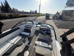 Interior view of a 2022 Bayliner VR5 boat with seating and steering wheel.