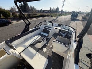 Interior view of a 2022 Bayliner VR5 boat showing seating and steering area.