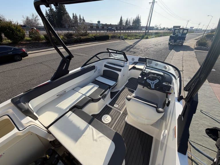 Interior view of a 2022 Bayliner VR5 boat showing seating and steering area.