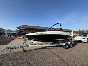 Bayliner VR5 boat on trailer at dealership lot, ready for water.