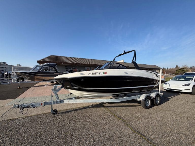 Bayliner VR5 boat on trailer at dealership lot, ready for water.