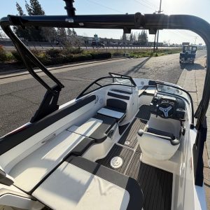 Modern Bayliner VR5 boat interior with seating and steering wheel.