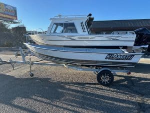 Klamath 15 Advantage S fishing boat on trailer at dealership.