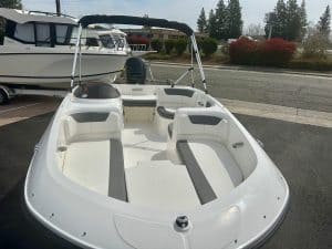 White boat with spacious seating and canopy, ideal for recreational boating and water adventures.