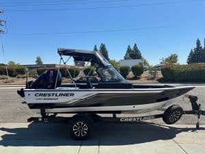 Crestliner Fish Hawk boat with Mercury 115HP outboard on trailer.