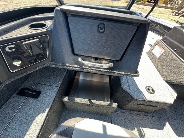 Close-up of boat storage compartment with lid open and handle visible.