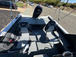 Boat interior with two seats and Mercury 115HP outboard motor.