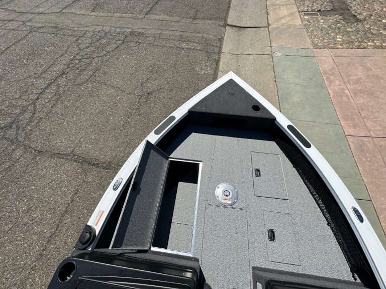 Close-up of boat interior with storage compartments and deck.