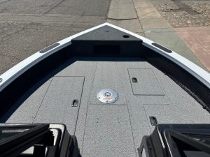 Boat deck with storage compartments and fishing accessories.