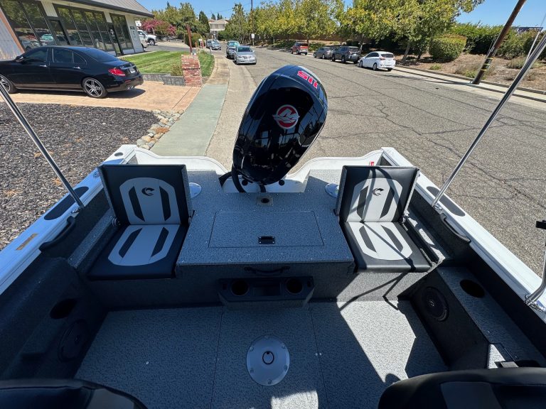 Boat interior with seating and Mercury 115HP outboard engine.