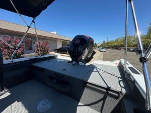 Boat with Mercury 115HP outboard motor on a sunny day.