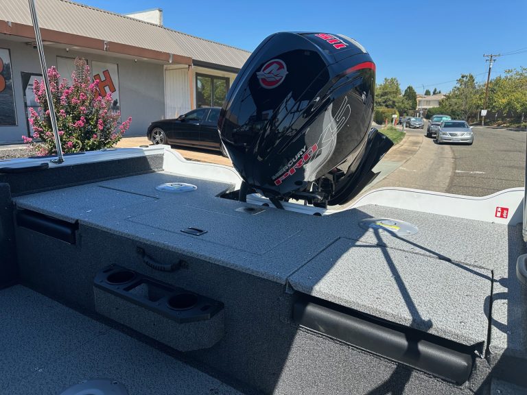 Boat with Mercury 115HP outboard motor on a trailer.