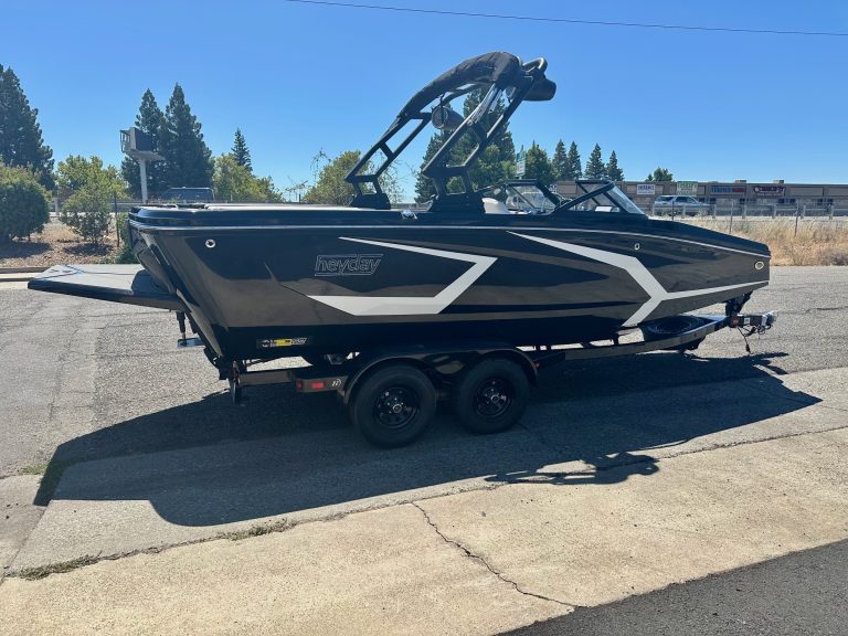 Modern black and white boat on trailer for sale or display.