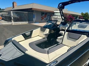 Modern boat with spacious seating and wakeboard tower for water sports.