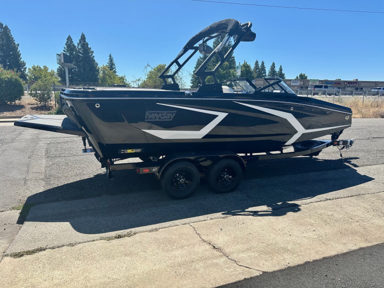 Black Heyday WT2 DC boat on trailer in outdoor setting.