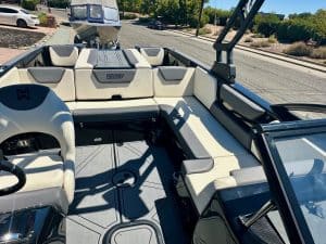 Close-up of a sleek, modern boat interior with comfortable seating and steering wheel.