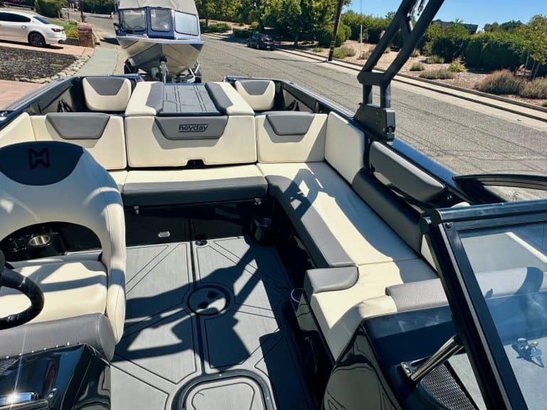 Close-up of a sleek, modern boat interior with comfortable seating and steering wheel.