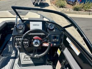Boat dashboard with steering wheel and navigation instruments for Rename Website.
