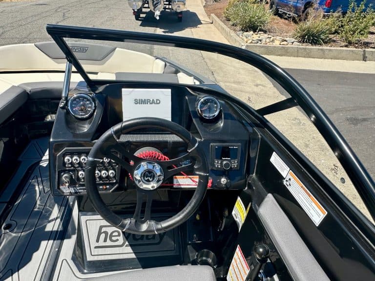 Boat dashboard with steering wheel and navigation instruments for Rename Website.