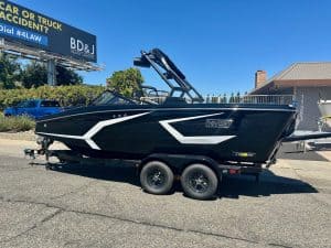 Luxury boat on trailer for sale at dealership.