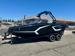 Modern black and white boat on trailer for sale or display.
