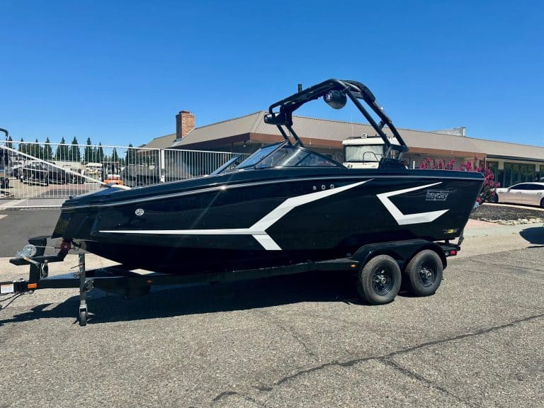 Modern black and white boat on trailer for sale or display.