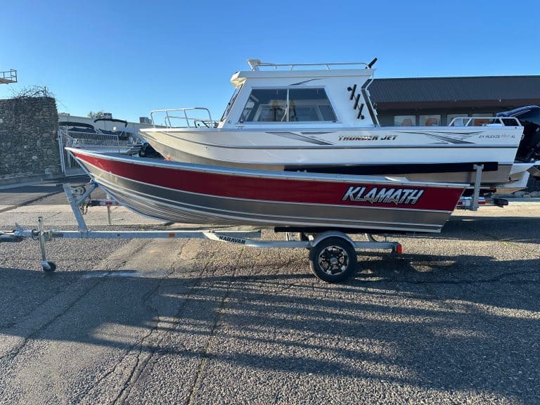 Klamath 2025 Advantage S fishing boat on trailer at marina.