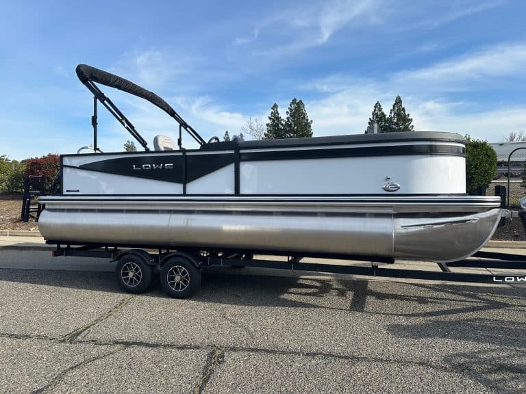 Tritoon boat with Mercury 150HP engine on trailer, ideal for family outings and water adventures.