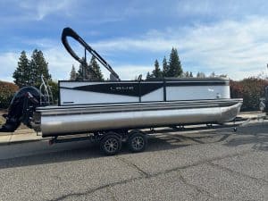 Lowe LS 23FT Tritoon boat with Mercury 150HP engine on trailer.