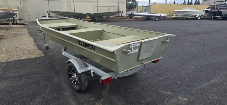 Klamath 10 JAC boat on trailer in outdoor lot.