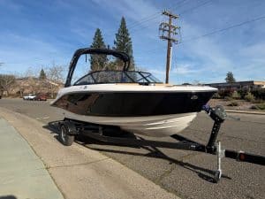 Boat on trailer with clear sky background.